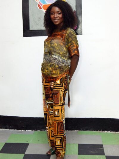 Woman wearing abstract print top with matching wide-leg trousers in warm earth tones